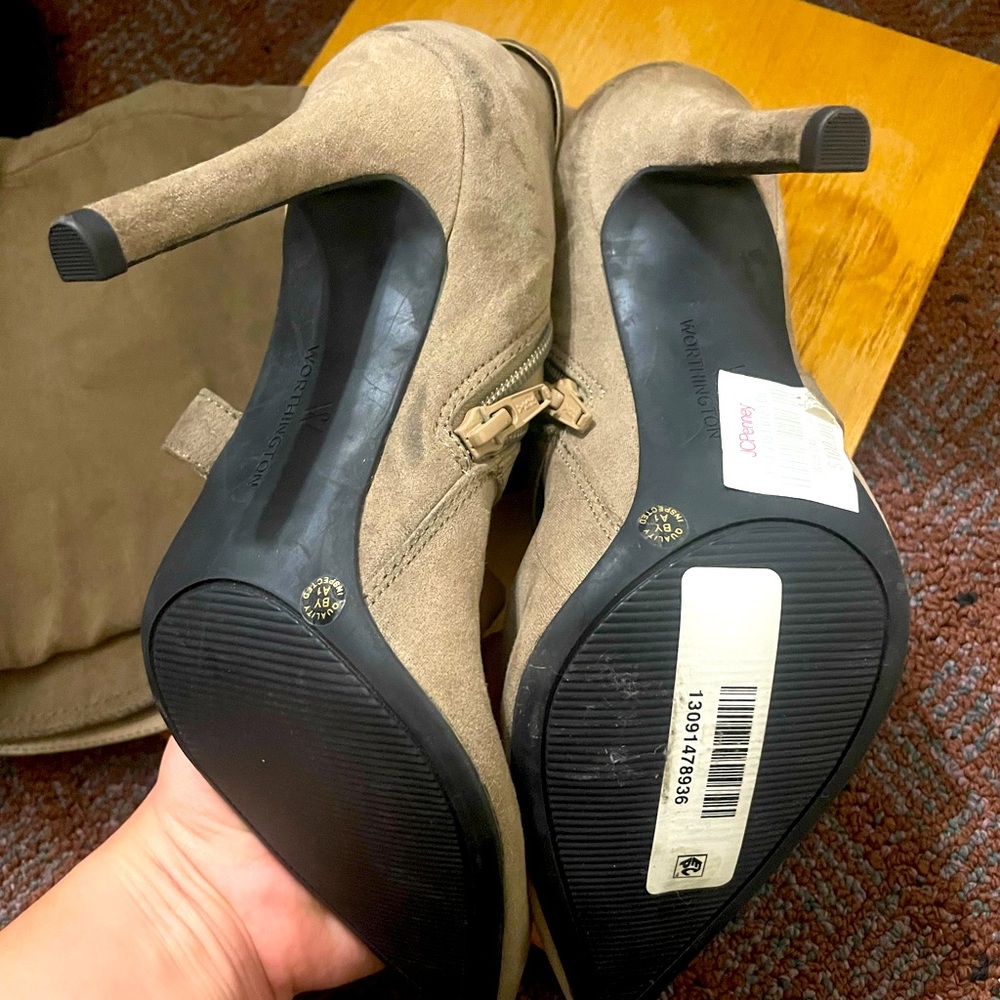 Knee high beige heeled boots.